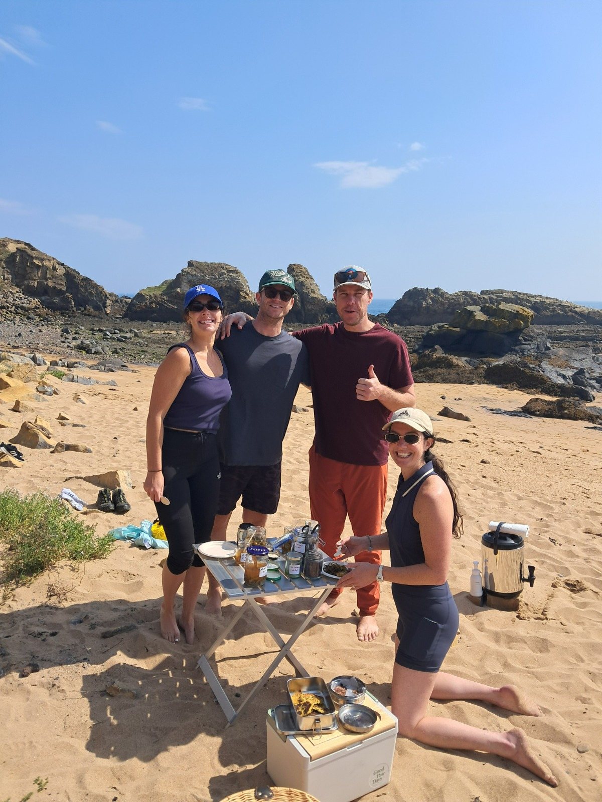 Four guests with Jayson at the beach kitchen on the sand