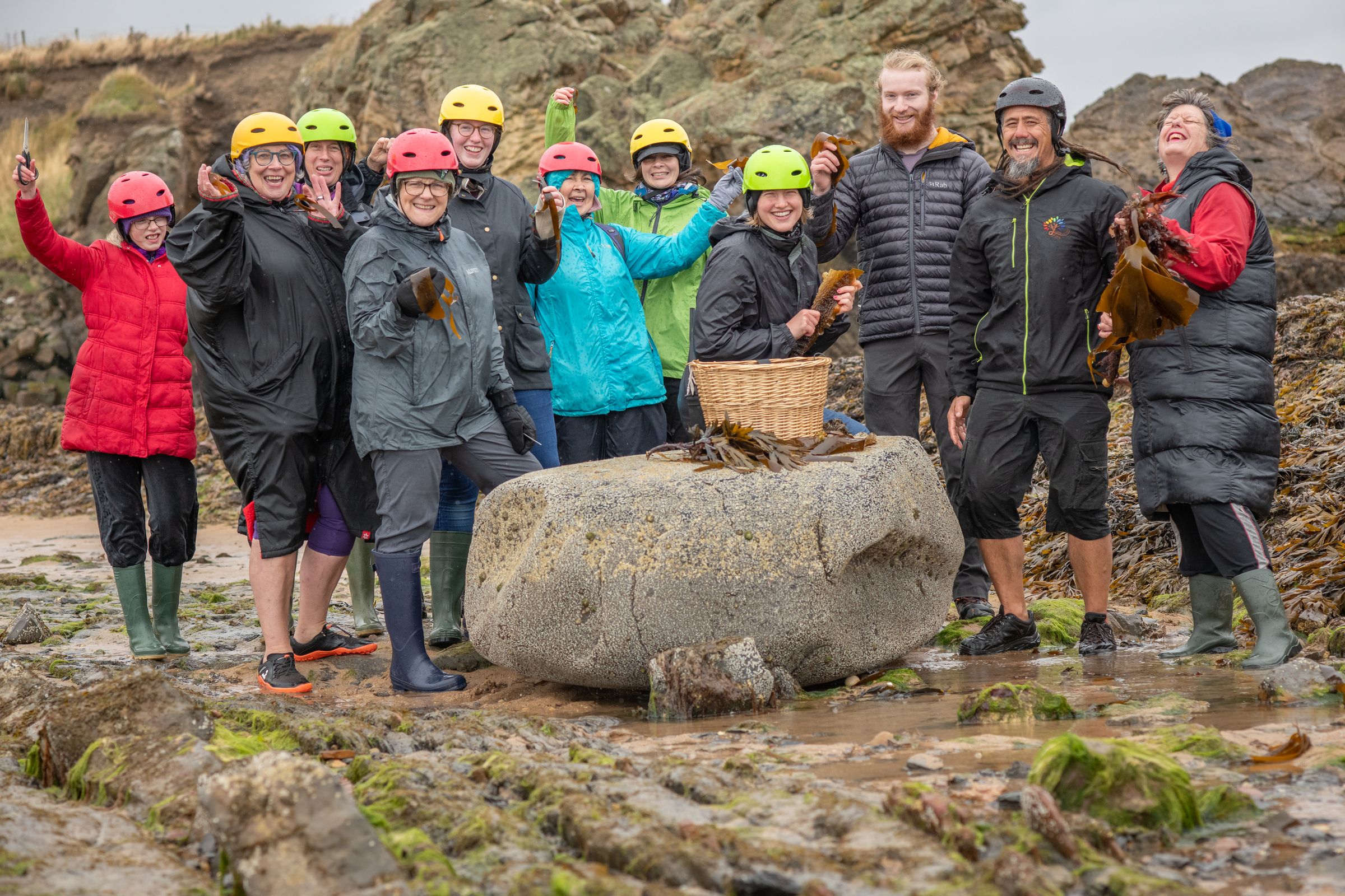 A workshop group celebrating on the rocks
