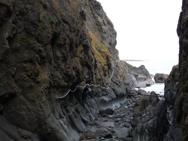 A horizontal chain fixed along a rock face a short distance above the sea near the east end of the Chain Walk