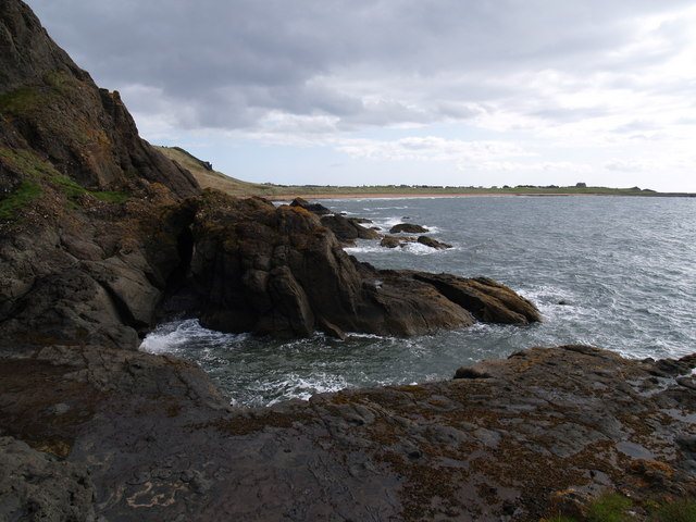 Rocky shore and cliffs of the Chain Walk looking east towards Earlsferry Links and the beach