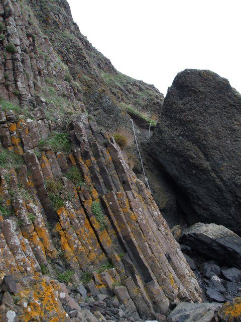 Tall vertical basalt columns on the Kincraig cliff, with a section of chain visible to the right